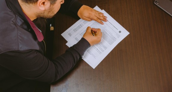 An Unusual Market Blogpost Hero Image- Homebuyer signing papers 