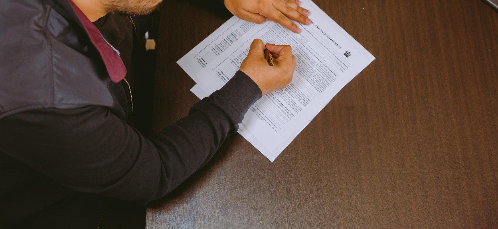 An Unusual Market Blogpost Hero Image- Homebuyer signing papers 