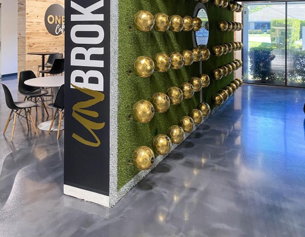 Realty ONE Group's The HUB in Laguna Niguel, CA featuring the 'soccer ball wall' where new franchise owners sign a ball and are welcomed to the ONE Family